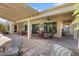 Backyard with a covered patio, multiple seating areas, and a ceiling fan at 20369 N 272Nd Ave, Buckeye, AZ 85396