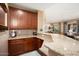 Entertain friends at this gorgeous wet bar with granite counters, and rich cabinetry at 20369 N 272Nd Ave, Buckeye, AZ 85396