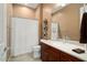 Charming guest bathroom features a vanity with dark wood cabinets and a shower with a curtain at 20369 N 272Nd Ave, Buckeye, AZ 85396
