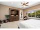 This primary bedroom features carpet flooring, a ceiling fan, and a large window at 20369 N 272Nd Ave, Buckeye, AZ 85396