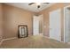 Neutral bedroom featuring carpet, ceiling fan, and a large mirror on the floor at 20369 N 272Nd Ave, Buckeye, AZ 85396