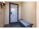 Elegant front door with decorative glass and a cozy bench, creating a welcoming entrance at 20369 N 272Nd Ave, Buckeye, AZ 85396