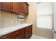 Laundry room with tile floors, dark cabinets and a white countertop at 20369 N 272Nd Ave, Buckeye, AZ 85396