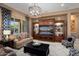 Living room showcasing the stylish decor, a custom media center, and view to outdoor pool at 20369 N 272Nd Ave, Buckeye, AZ 85396