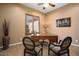 Cozy home office with a classic wooden desk, comfortable chairs, and a well-lit window, perfect for remote work at 20369 N 272Nd Ave, Buckeye, AZ 85396