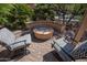 Outdoor patio with two patterned chairs, a fire pit, and palm trees at 20369 N 272Nd Ave, Buckeye, AZ 85396