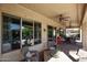 Spacious covered patio with comfortable seating, ceiling fans, and access to the backyard at 20369 N 272Nd Ave, Buckeye, AZ 85396