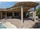 Large covered patio with ample seating, ceiling fans, and a view of the lush backyard and pool at 20369 N 272Nd Ave, Buckeye, AZ 85396