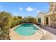 Backyard pool with desert landscaping, a handrail for entering, and an adjacent outdoor patio at 20369 N 272Nd Ave, Buckeye, AZ 85396