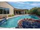 Inviting pool with water feature and a spacious covered patio for outdoor living at 20369 N 272Nd Ave, Buckeye, AZ 85396