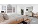 Serene bedroom with a platform bed, neutral decor, and natural light from large windows at 20435 N 39Th Dr, Glendale, AZ 85308