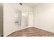 Simple bedroom with wood-look flooring and access to hallway at 20435 N 39Th Dr, Glendale, AZ 85308
