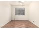 Bright bedroom with wood-look flooring and ceiling fan at 20435 N 39Th Dr, Glendale, AZ 85308