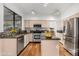 Well-lit kitchen featuring stainless steel appliances, light cabinetry, and hardwood flooring at 20435 N 39Th Dr, Glendale, AZ 85308