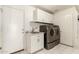 Laundry room with washer, dryer, sink, and ample cabinetry at 20435 N 39Th Dr, Glendale, AZ 85308