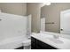 Bathroom with tub, toilet and dark vanity at 22174 E Creekside Dr, Queen Creek, AZ 85142