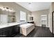 Elegant bathroom with double sinks, a soaking tub, and a walk-in shower at 22174 E Creekside Dr, Queen Creek, AZ 85142
