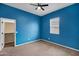Blue-walled bedroom with carpet and walk-in closet at 22174 E Creekside Dr, Queen Creek, AZ 85142