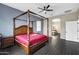 Spacious Primary bedroom with a large four-poster bed and ensuite bathroom access at 22174 E Creekside Dr, Queen Creek, AZ 85142