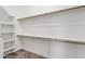 Large walk-in closet with ample shelving and hanging space for storage at 22174 E Creekside Dr, Queen Creek, AZ 85142