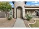 Front entrance with arched entryway and landscaping at 22174 E Creekside Dr, Queen Creek, AZ 85142