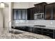 Modern kitchen with granite countertops and dark cabinetry at 22174 E Creekside Dr, Queen Creek, AZ 85142