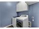 Laundry room with washer, dryer and upper cabinets at 22174 E Creekside Dr, Queen Creek, AZ 85142