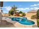 Inviting kidney shaped pool with surrounding patio at 22174 E Creekside Dr, Queen Creek, AZ 85142