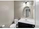 Clean powder room with vanity, toilet, and oval mirror at 22174 E Creekside Dr, Queen Creek, AZ 85142