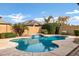 Inviting kidney-shaped pool with waterfall feature in a private backyard setting at 22174 E Creekside Dr, Queen Creek, AZ 85142