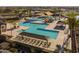 Community pool area, showcasing a pool with cabanas, lounge chairs and palm trees at 22922 E Mayberry Rd, Queen Creek, AZ 85142