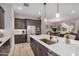 This open kitchen features a large island with a sink, custom cabinets, and stainless steel appliances at 22922 E Mayberry Rd, Queen Creek, AZ 85142