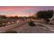 Landscaped backyard with fire pit, stone pathway, and desert plants at 23187 W Lasso Ln, Buckeye, AZ 85326
