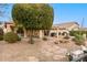 Backyard with covered patio, desert landscaping, and stone pathway at 23187 W Lasso Ln, Buckeye, AZ 85326