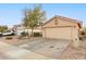 View of home's exterior, including garage and driveway at 23187 W Lasso Ln, Buckeye, AZ 85326