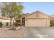 Single story home with two car garage and desert landscaping at 23187 W Lasso Ln, Buckeye, AZ 85326