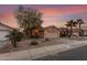 Single story home with two car garage and desert landscaping at 23187 W Lasso Ln, Buckeye, AZ 85326
