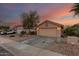 Single story home with two car garage and desert landscaping at 23187 W Lasso Ln, Buckeye, AZ 85326