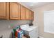 Convenient laundry room with washer, dryer, and cabinets at 23187 W Lasso Ln, Buckeye, AZ 85326