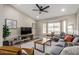 Living room with gray sectional sofa, bay window, and wood coffee table at 2617 E Dartmouth St, Mesa, AZ 85213