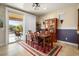 Dining area with wooden table and access to a backyard patio at 26343 W Tina Ln, Buckeye, AZ 85396