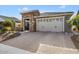 Single-story home with stone and tile accents, two-car garage at 26467 W Zachary Dr, Buckeye, AZ 85396