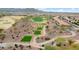 Aerial view of a community with a golf course and walking path at 26702 W Sierra Pinta Dr, Buckeye, AZ 85396