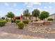 Landscaped backyard with stone retaining walls at 26702 W Sierra Pinta Dr, Buckeye, AZ 85396