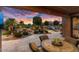 Backyard patio with seating area, fountain, and sunset view at 26702 W Sierra Pinta Dr, Buckeye, AZ 85396