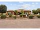 Single-story home with a landscaped backyard, featuring a patio and lush greenery at 26702 W Sierra Pinta Dr, Buckeye, AZ 85396