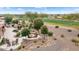 Landscaped backyard oasis with fire pit and outdoor kitchen at 26702 W Sierra Pinta Dr, Buckeye, AZ 85396