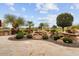 Landscaped backyard with water feature and patio at 26702 W Sierra Pinta Dr, Buckeye, AZ 85396