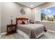 Bright bedroom with a queen bed, wood furniture, and window shutters at 26702 W Sierra Pinta Dr, Buckeye, AZ 85396