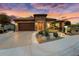 Single-story home with stone accents and beautifully landscaped front yard at 26702 W Sierra Pinta Dr, Buckeye, AZ 85396